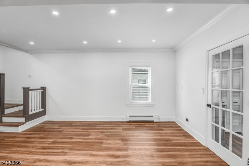 1017 Grandview Avenue Union, NJ 07083 - Photo 7 of 34 a view of an empty room with wooden floor and a window