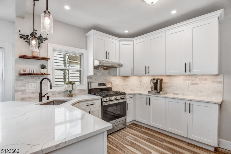 1017 Grandview Avenue Union, NJ 07083 - Photo 9 of 34 a kitchen with stainless steel appliances granite countertop a sink stove and cabinets