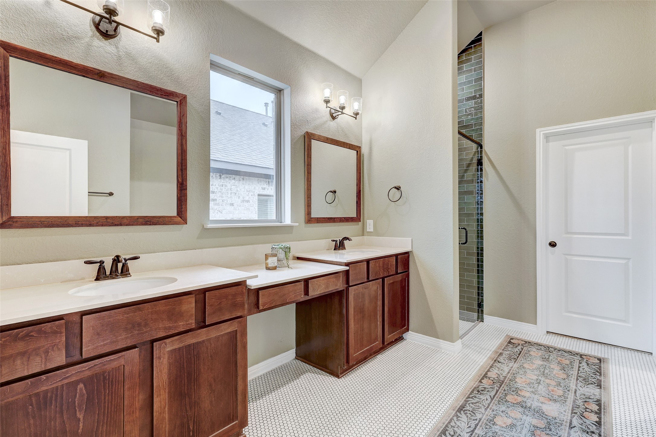 1117 Spring Gulch Lane Georgetown, TX 78628 - Photo 23 of 39 A generous double vanity with ample counter space and a tiled shower defines this well-appointed bathroom.