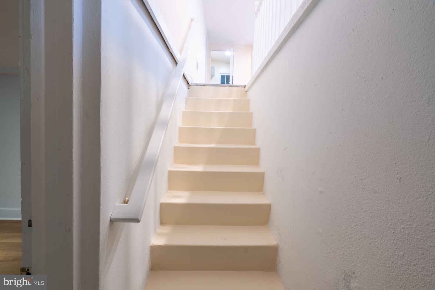 7313 Dooman Road Baltimore, MD 21244 - Photo 17 of 35 a view of staircase with white walls and white door