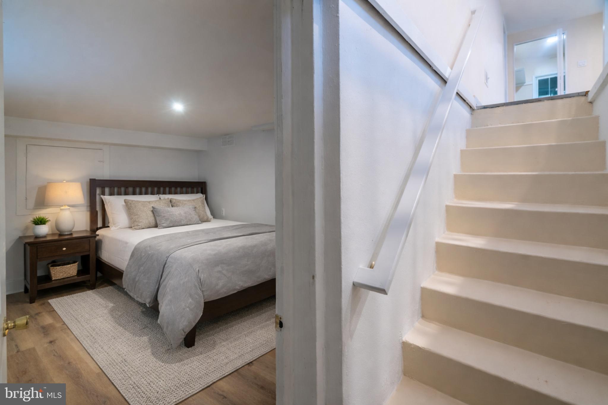 7313 Dooman Road Baltimore, MD 21244 - Photo 19 of 35 a bedroom with a bed and a night stand