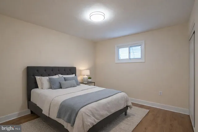 a bedroom with a bed and a night stand