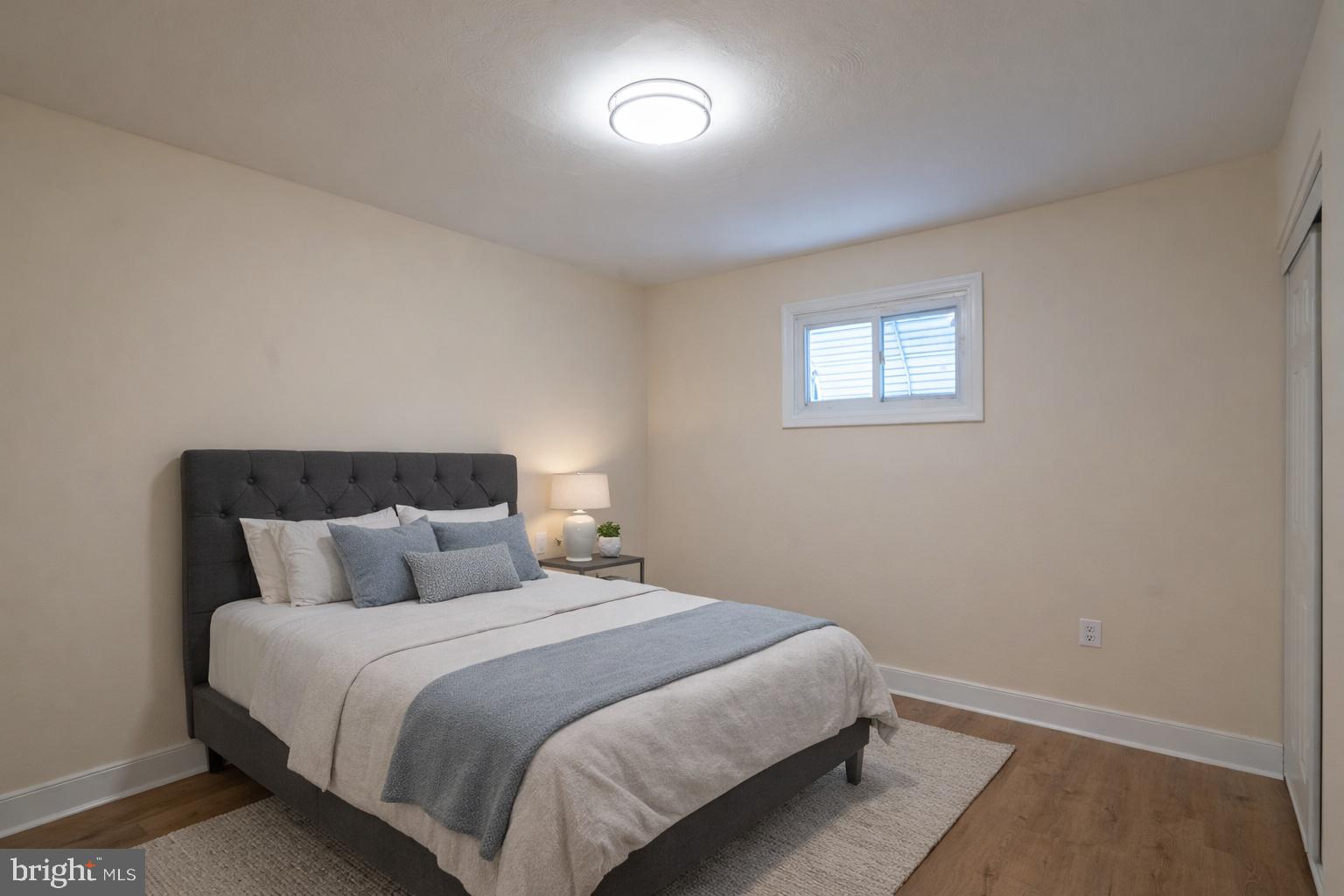 7313 Dooman Road Baltimore, MD 21244 - Photo 22 of 35 a bedroom with a bed and a night stand