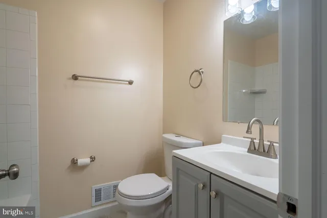 a bathroom with a sink toilet and vanity