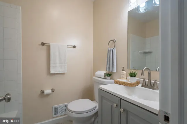 a bathroom with a sink toilet and mirror