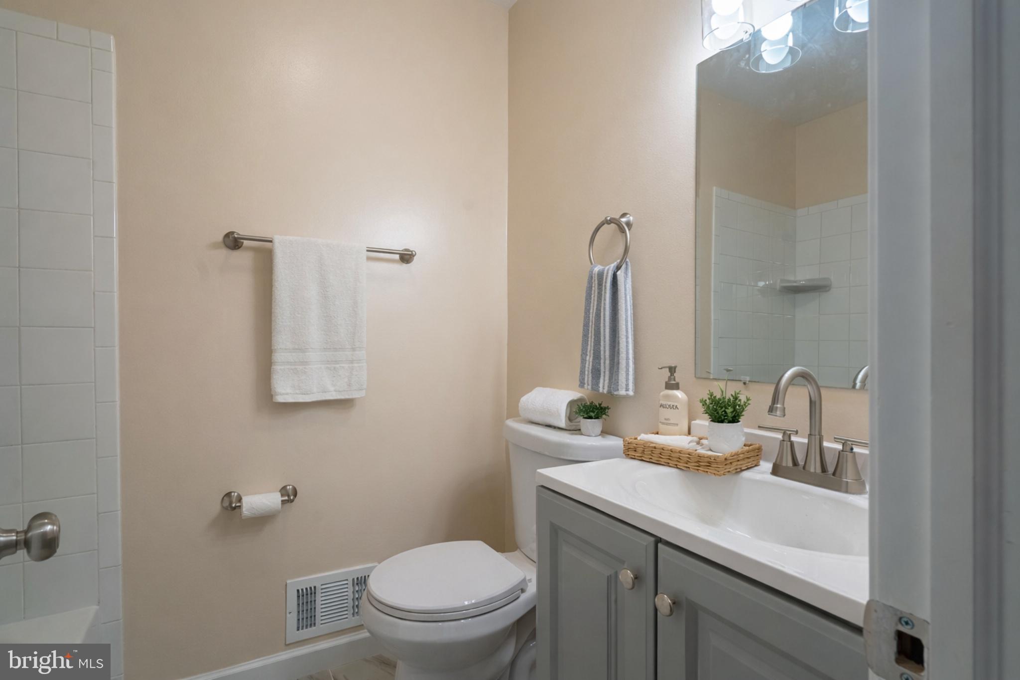 7313 Dooman Road Baltimore, MD 21244 - Photo 27 of 35 a bathroom with a sink toilet and mirror