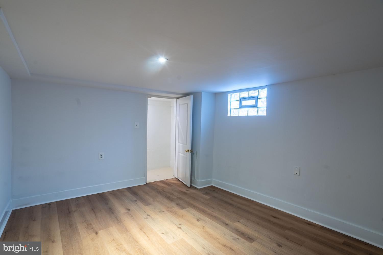 7313 Dooman Road Baltimore, MD 21244 - Photo 34 of 35 an empty room with wooden floor and windows
