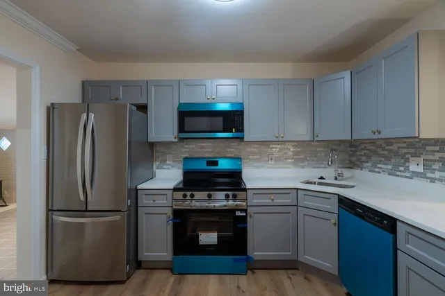 a kitchen with a sink stove and refrigerator