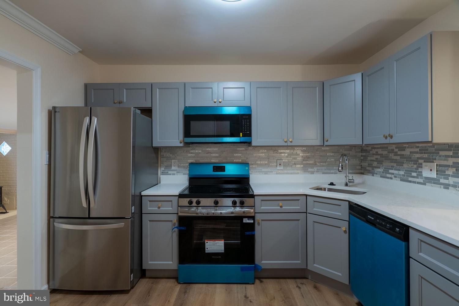7313 Dooman Road Baltimore, MD 21244 - Photo 6 of 35 a kitchen with a sink stove and refrigerator