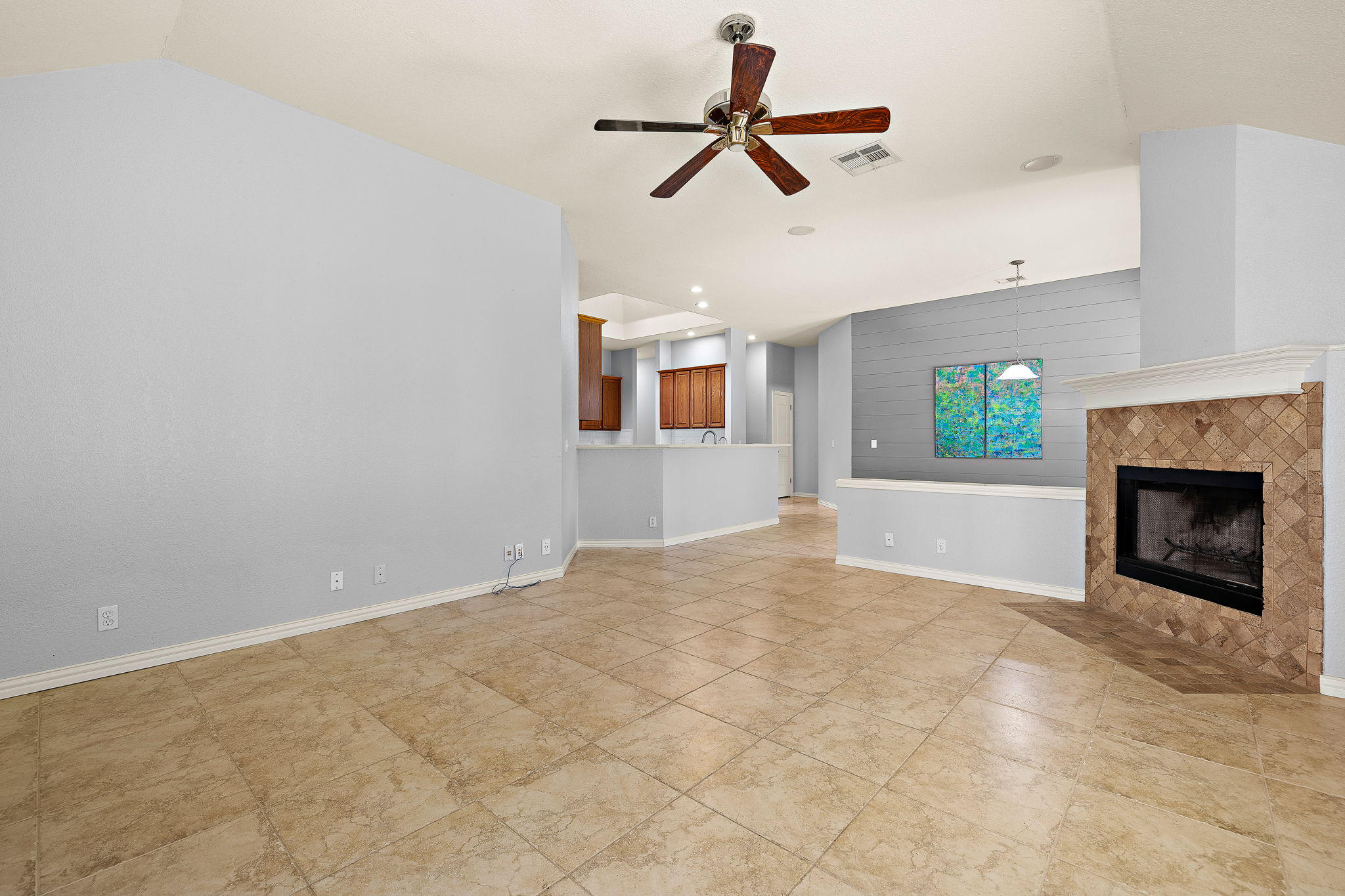 1102 Nelson Ranch Road Cedar Park, TX 78613 - Photo 9 of 37 A spacious living area features elegant tiled flooring and a cozy fireplace, perfect for gatherings.