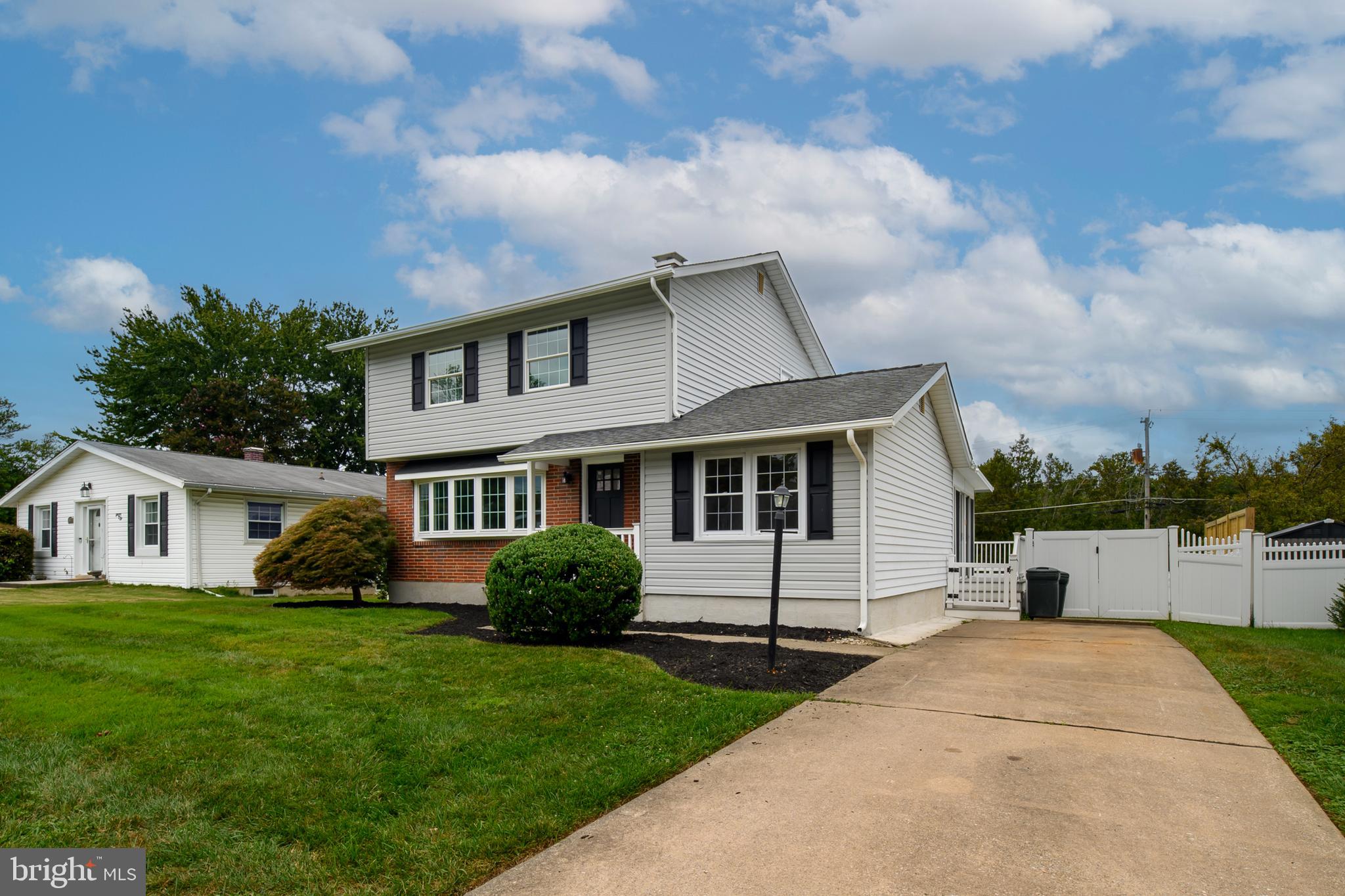 8921 Parlo Road Nottingham, MD 21236 - Photo 4 of 40 a front view of a house with a garden and trees