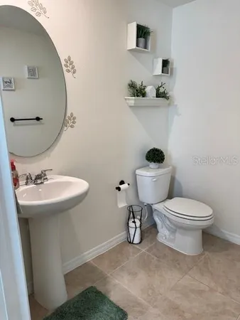 a bathroom with a sink a toilet and mirror