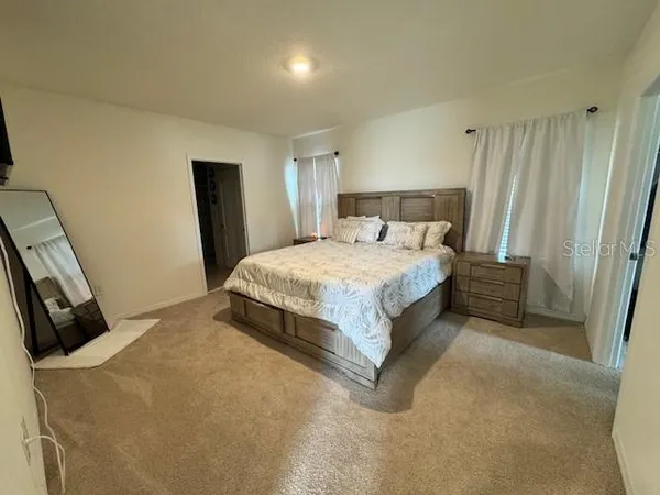 a bedroom with a bed and a dresser