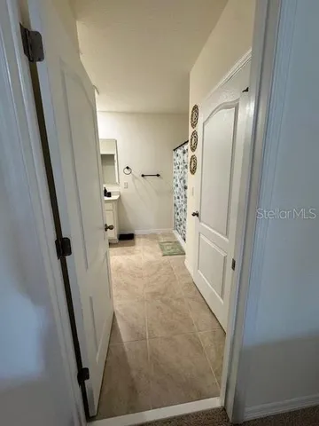 a spacious bathroom with a sink and a mirror