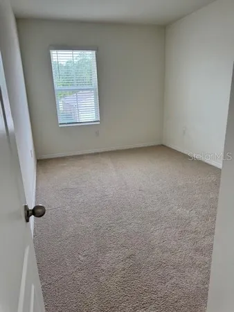 a bedroom with a bed and chair