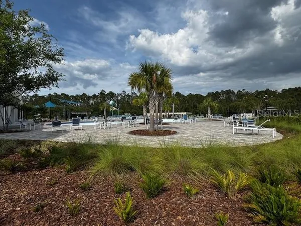 an aerial view of a house with swimming pool and patio