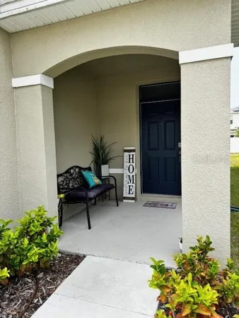 a living room with furniture and flowers