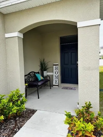 a living room with furniture and flowers