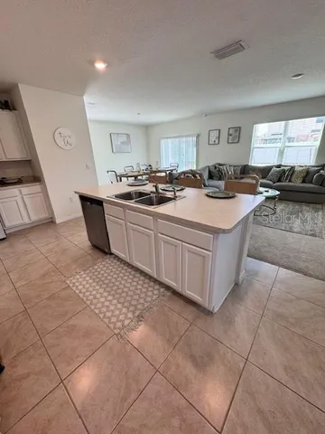 a large white kitchen with a large window