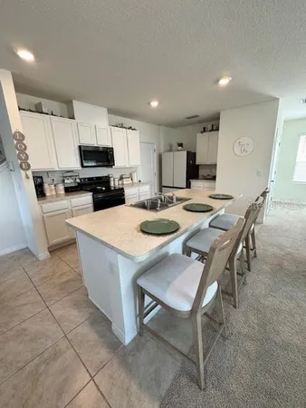 a kitchen with appliances a sink and cabinets
