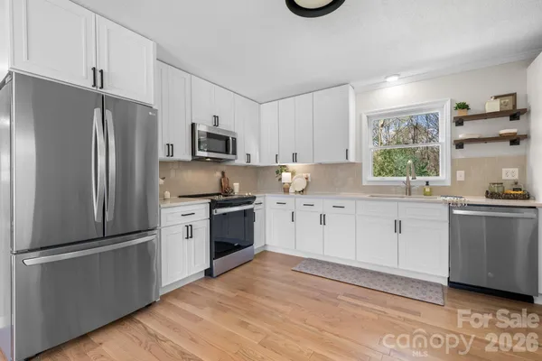 a kitchen with a refrigerator stove and sink
