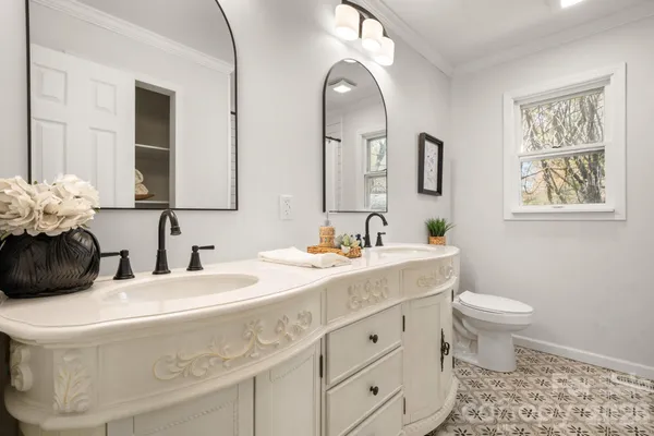 a bathroom with a toilet sink and mirror