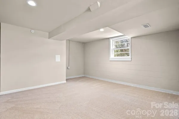 an empty room with windows and closet