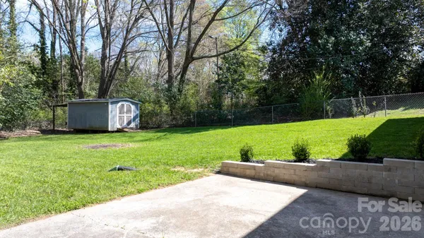 a view of a backyard with large trees