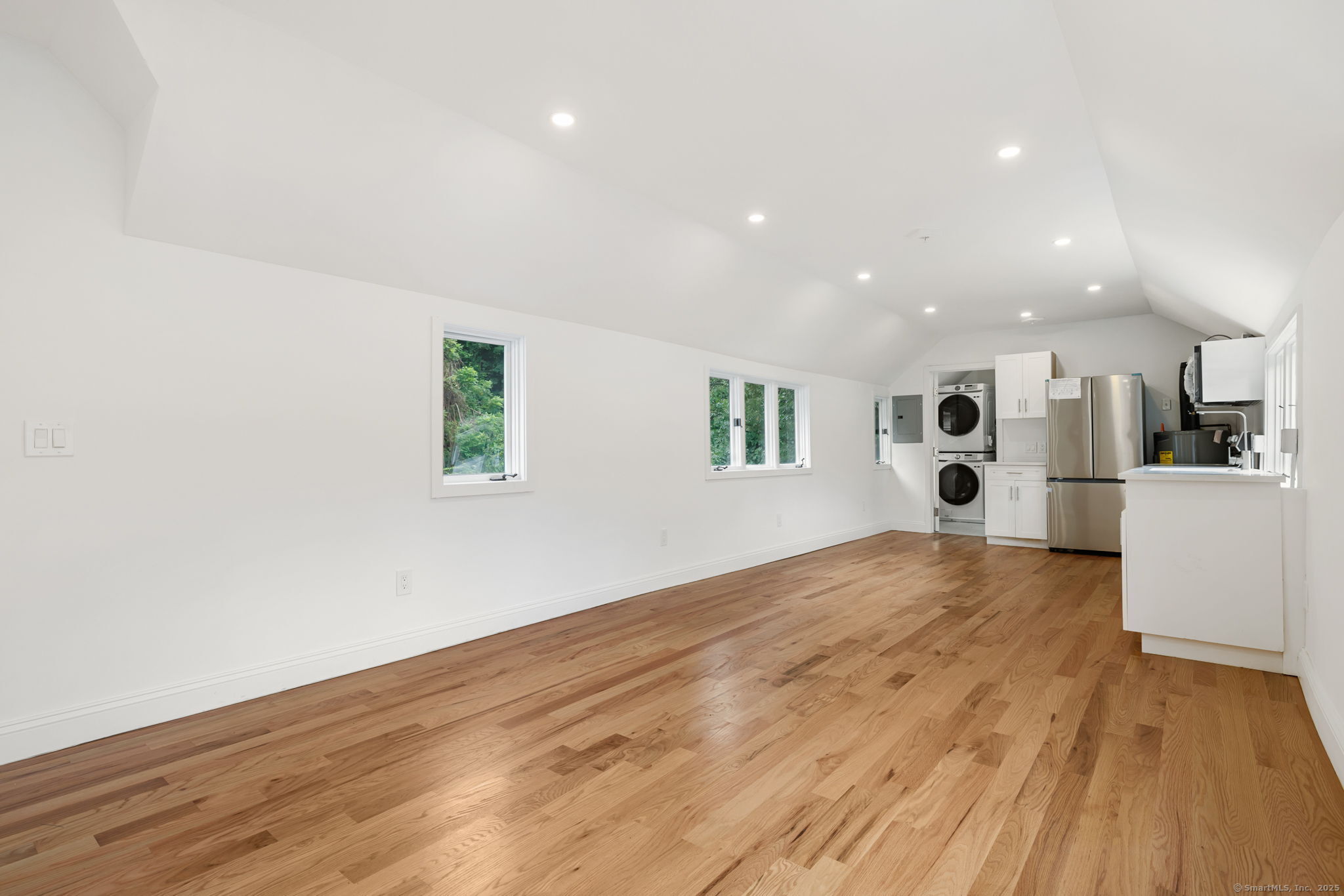a view of a kitchen with wooden floor and a sink