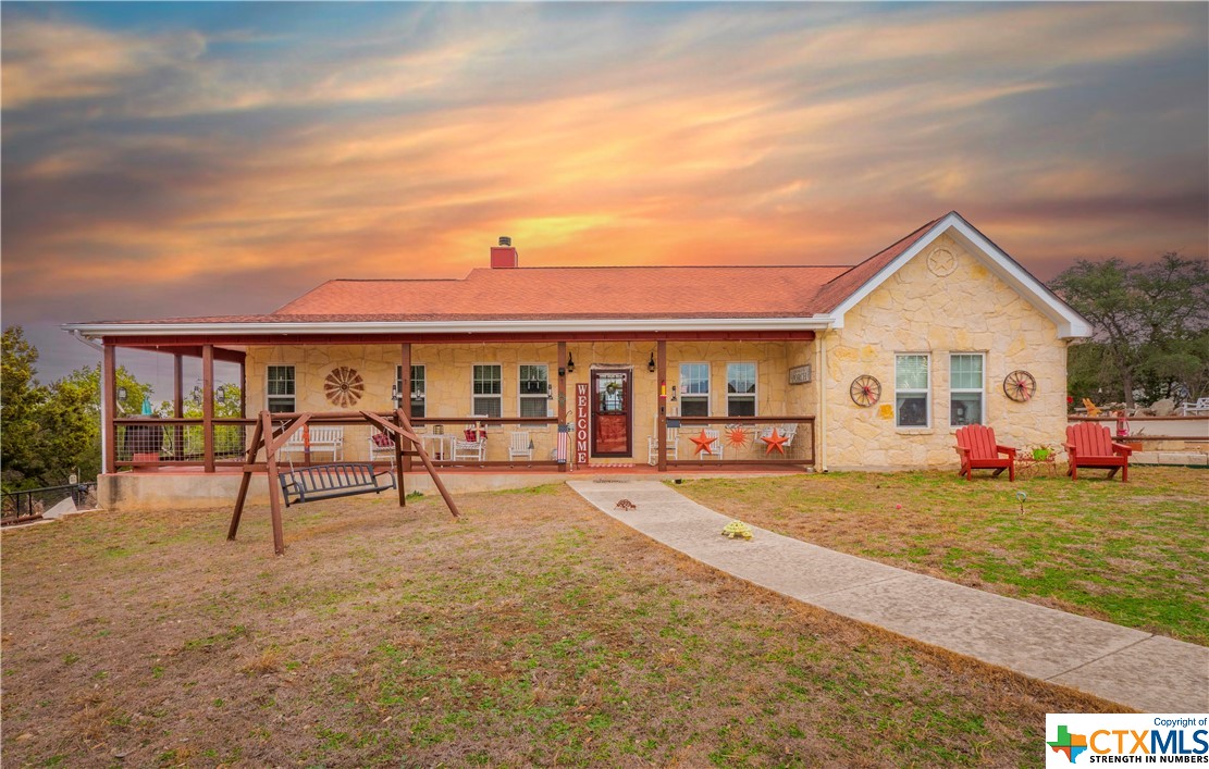 a view of a house with a yard and sitting area