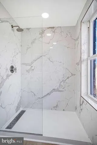 a bathroom with a shower and a tub