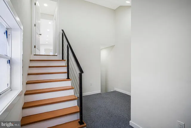 a view of entryway with wooden floor and stairs