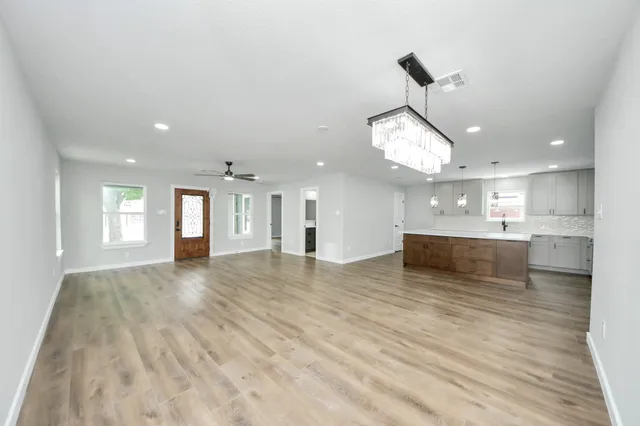a large kitchen with kitchen island a sink stainless steel appliances and cabinets
