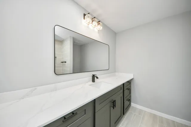 a bathroom with a bathtub a sink a vanity and a shower