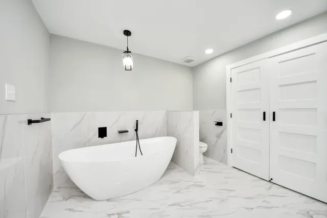 a view of a big room with wooden floor and windows