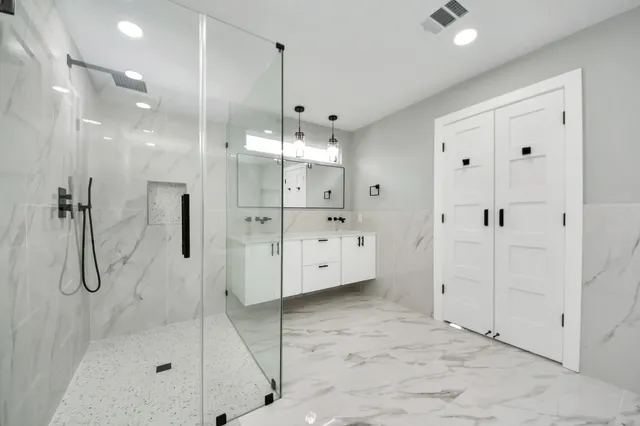 a view of a room with wooden floor and electronic appliances