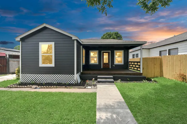 a front view of a house with a garden
