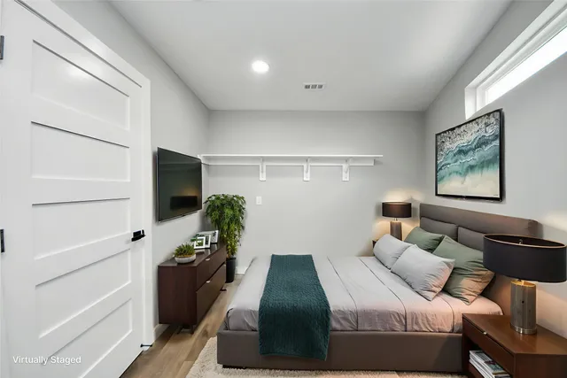 a aerial view of multi story residential apartment building with yard and retail shops