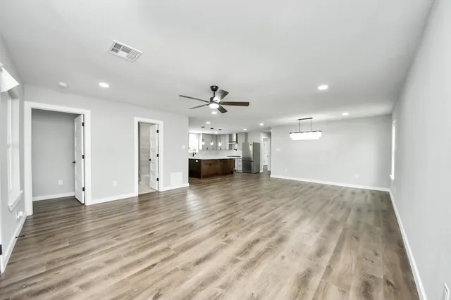 a living room with furniture a flat screen tv and a table