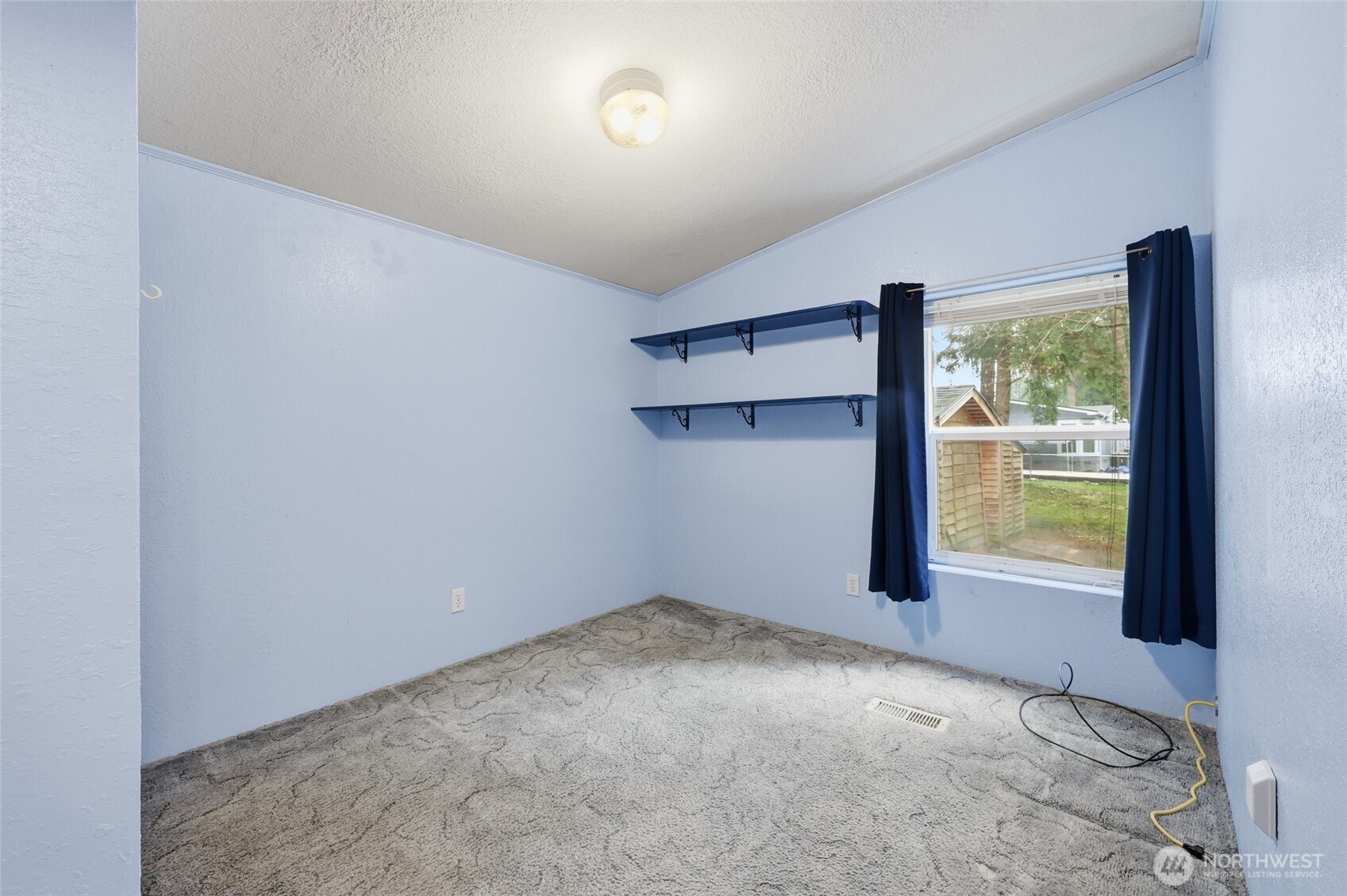 17340 Sargent Road Southwest, Unit 54 Rochester, WA 98579 - Photo 12 of 30 an empty room with windows