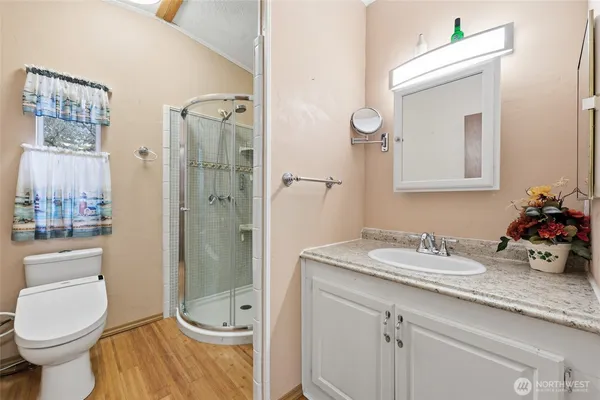 a bathroom with a granite countertop sink toilet and shower