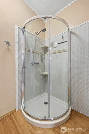a bathroom with a glass shower door
