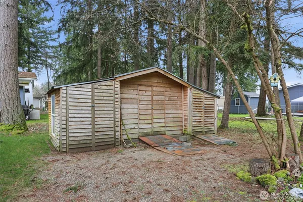 a view of a house with a yard and tree