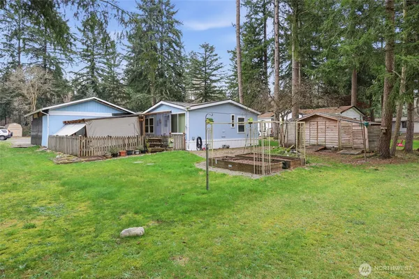 a view of a house with a yard and sitting area