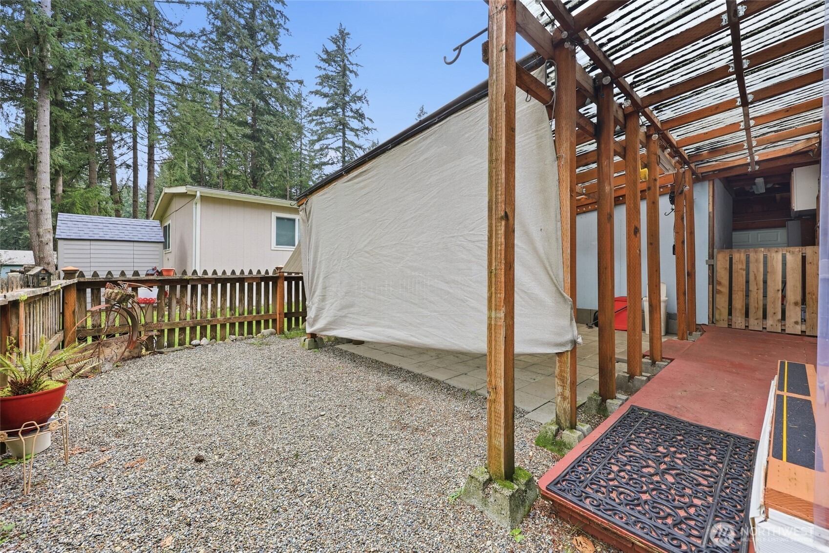 17340 Sargent Road Southwest, Unit 54 Rochester, WA 98579 - Photo 23 of 30 a view of a small yard next to a house