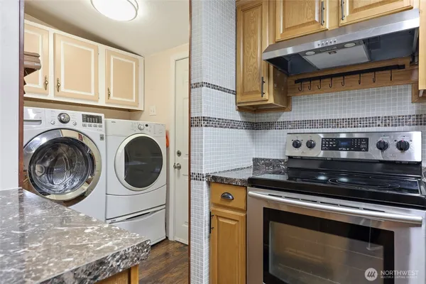 a view of a kitchen with a stove top oven