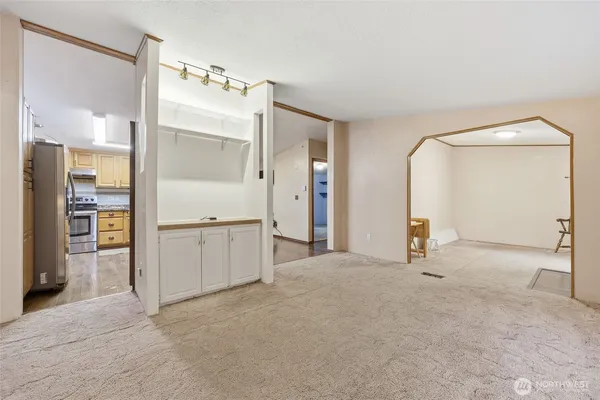 an empty room with a mirror and a wooden floors