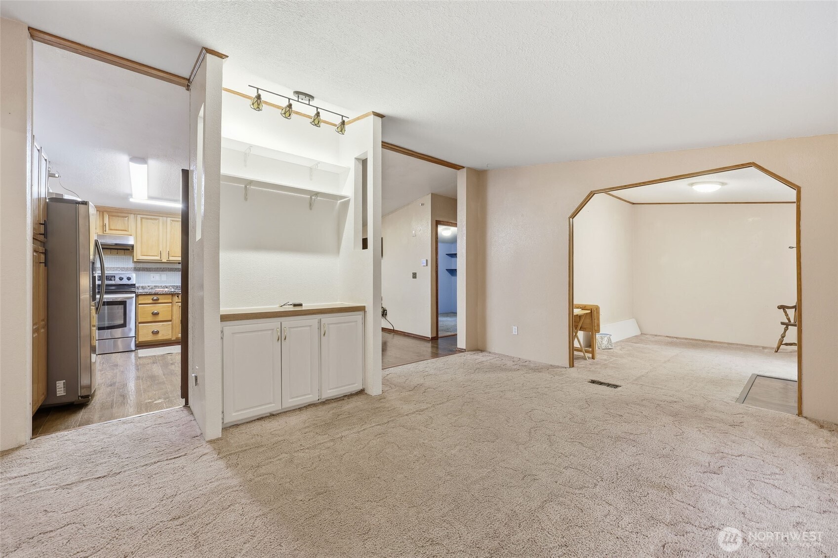 17340 Sargent Road Southwest, Unit 54 Rochester, WA 98579 - Photo 5 of 30 an empty room with a mirror and a wooden floors