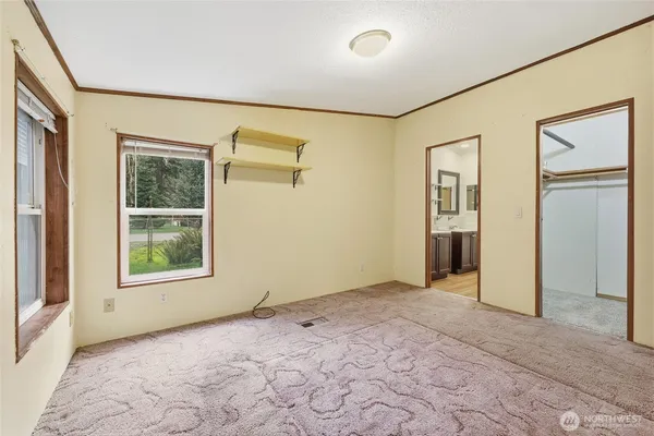 an empty room with windows and closet