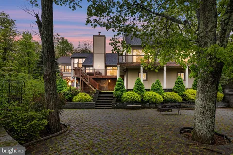 aerial view of a house with backyard porch and sitting area